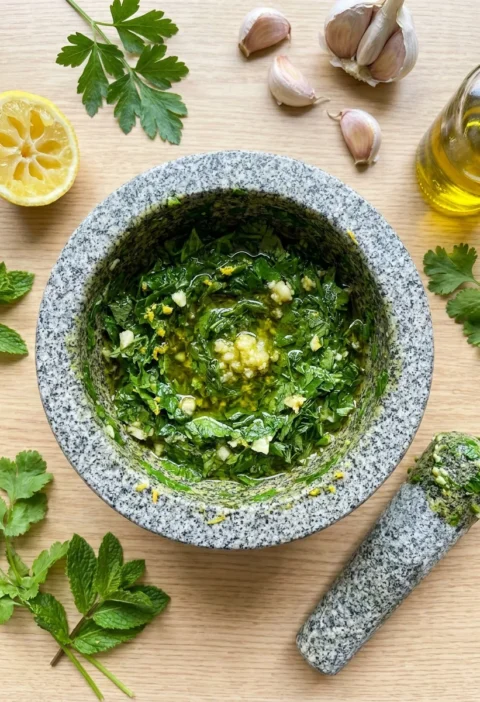 Gordon Ramsay chimichurri sauce pounded in a granite mortar with fresh herbs