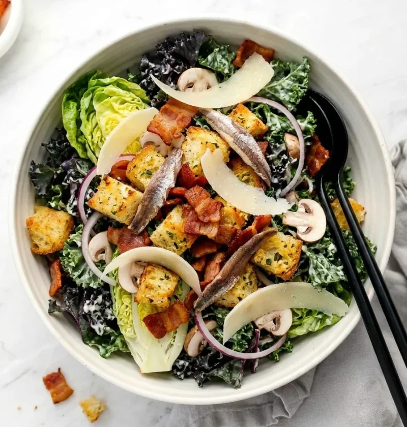 Kale caesar salad with bacon lardons, sourdough croutons, anchovies and Parmesan shavings