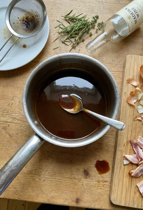 Gordon Ramsay Madeira sauce in a saucepan with cooking mess