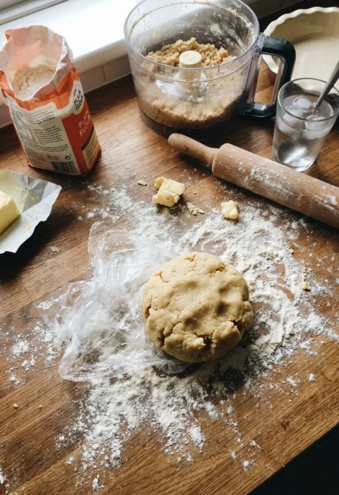 Gordon Ramsay pie crust shortcrust pastry dough on a floured wooden worktop with a food processor rolling pin butter and ice water