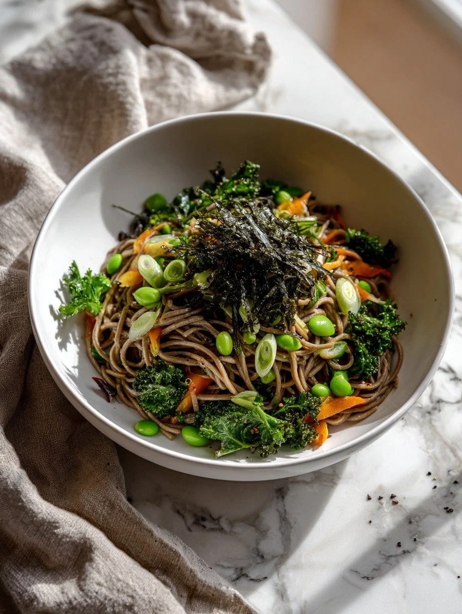 Soba noodle salad with spring onions, edamame and kale in natural light