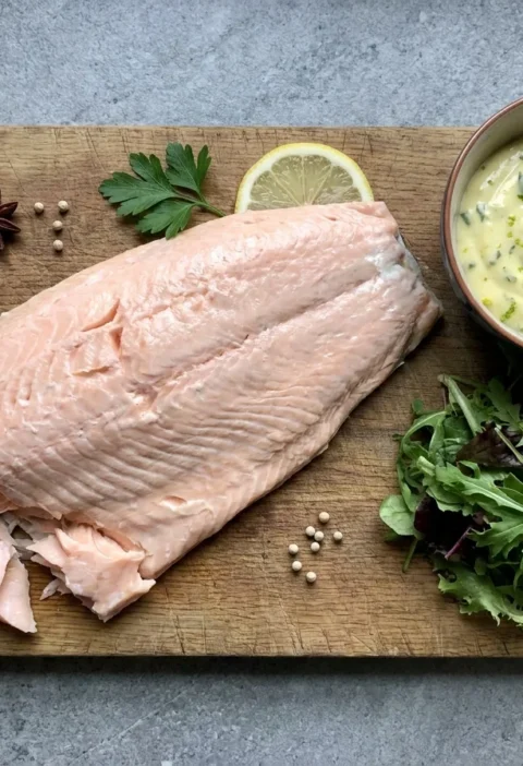 Gordon Ramsay poached side of salmon, pale and flaky, served with tarragon mayonnaise and a leafy salad