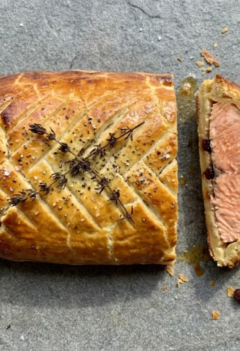 Gordon Ramsay salmon en croute sliced to show pink salmon and currant butter inside golden shortcrust pastry