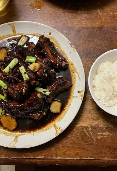 Gordon Ramsay sticky pork ribs with dark glossy soy and honey glaze, star anise and spring onions