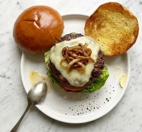 Gordon Ramsay wagyu burger with butter-basted patty, melted Monterey Jack, caramelised onions, lettuce and tomato in a toasted brioche bun