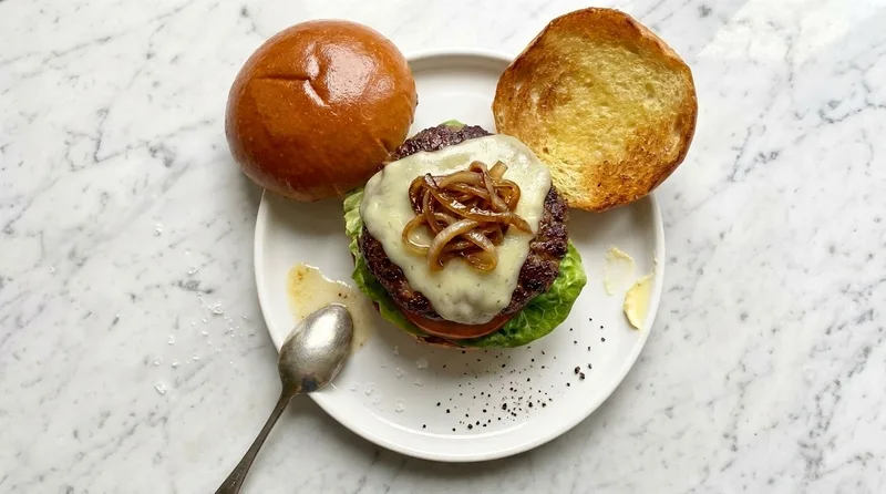 Gordon Ramsay wagyu burger with butter-basted patty, melted Monterey Jack, caramelised onions, lettuce and tomato in a toasted brioche bun