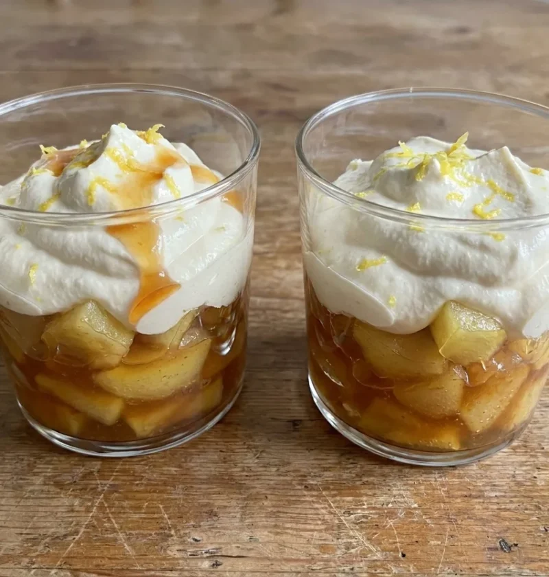 Gordon Ramsay apple compote layered in glasses with caramelised apple chunks under whipped cream and lemon zest