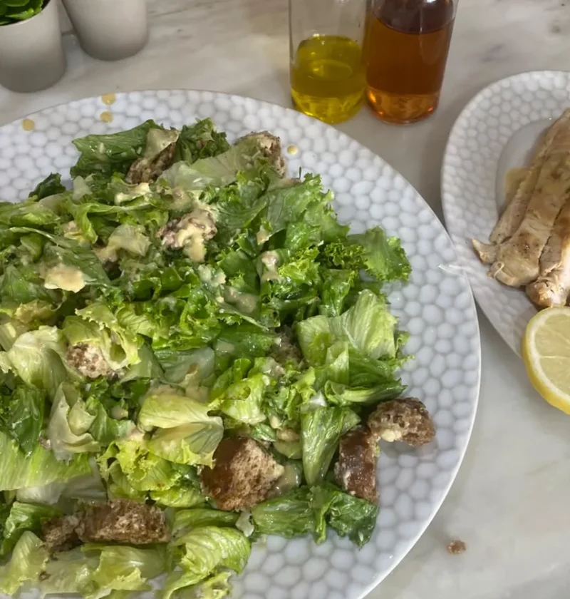 Gordon Ramsay caesar salad with Parmesan croutons and homemade anchovy dressing, griddled chicken and lemon served alongside