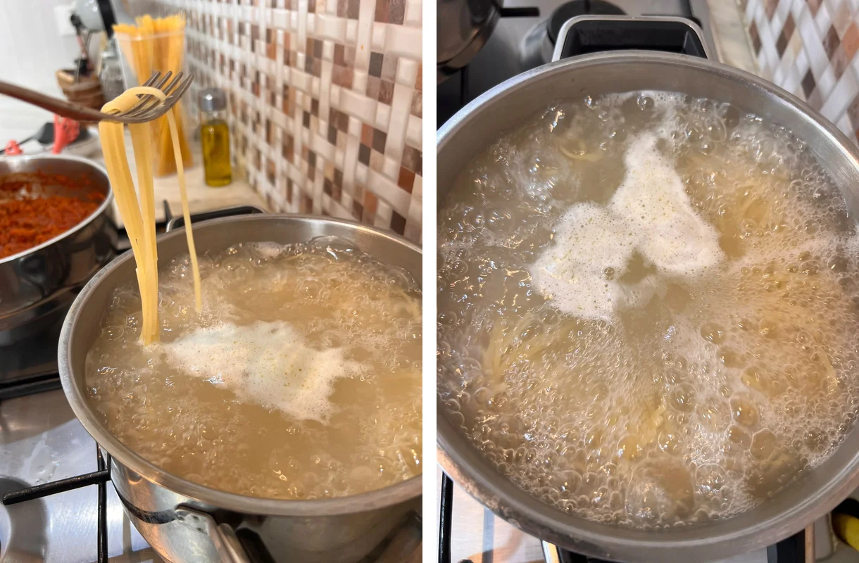 Spaghetti cooking at a rolling boil, with a strand lifted on a fork for the al dente test
